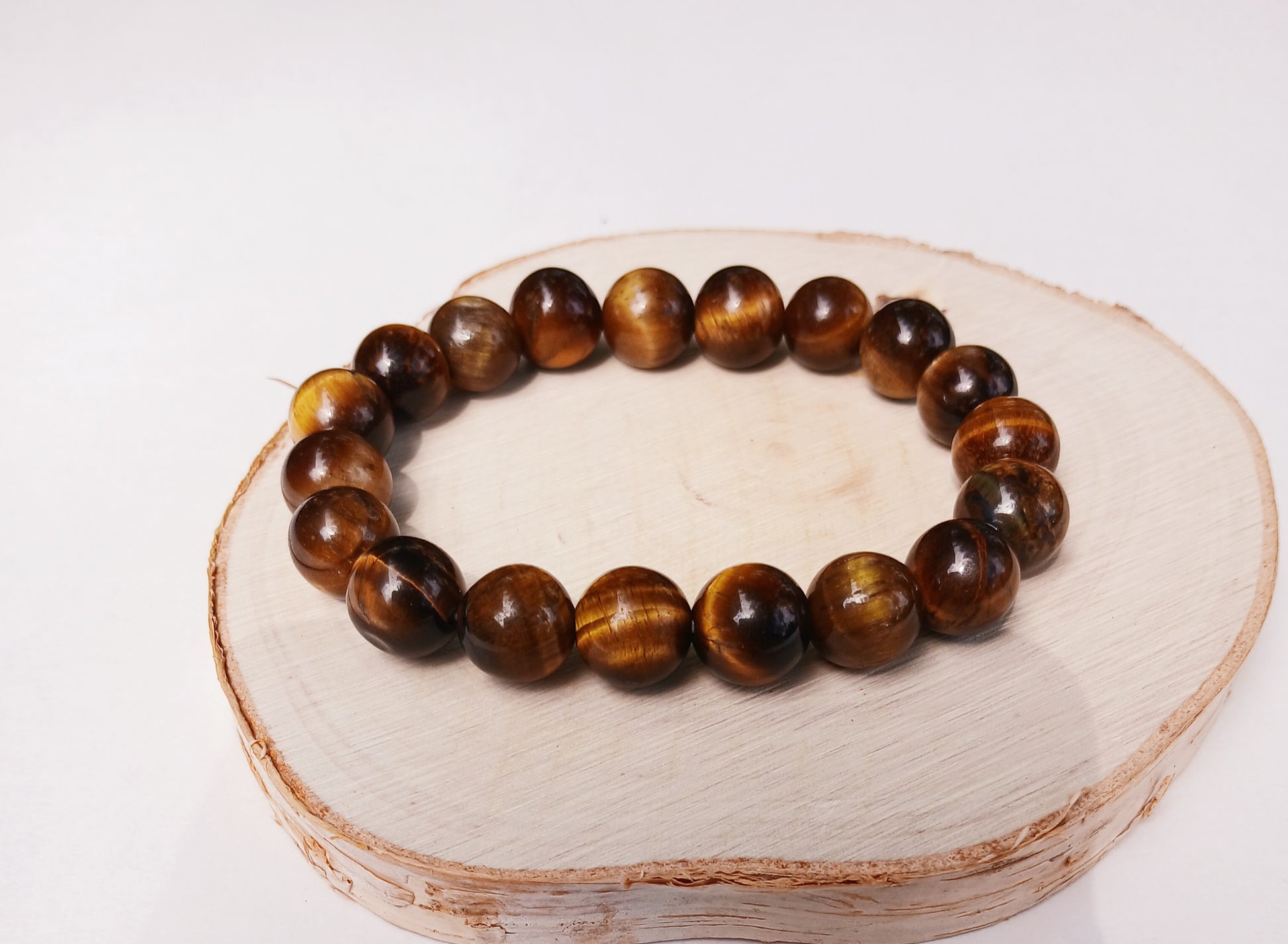 Tiger Eye Bracelet for men featuring natural healing crystals known for protection, strength, and balance. This stylish spiritual jewelry is designed to promote positive energy and calm, making it a meaningful gift for him—perfect for husbands or boyfriends. Handmade with quality beads, it combines durability and fashion for everyday wear. Ideal for meditation, casual outfits, or special occasions, blending wellness with masculine style.