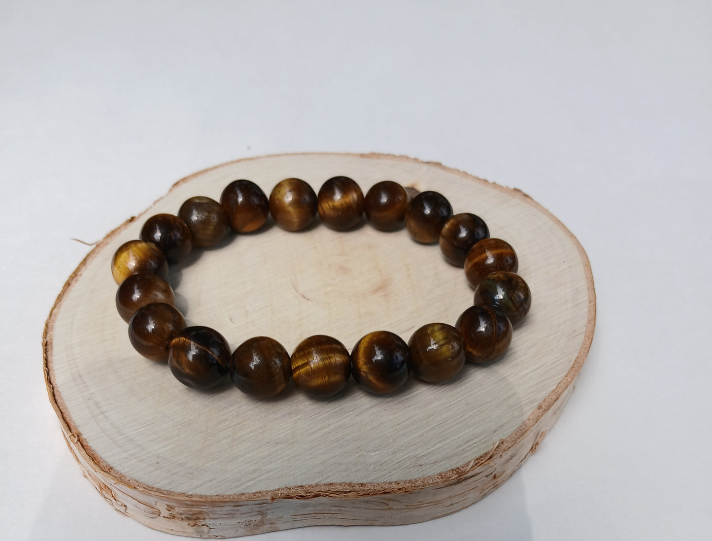 Tiger Eye Bracelet for men featuring natural healing crystals known for protection, strength, and balance. This stylish spiritual jewelry is designed to promote positive energy and calm, making it a meaningful gift for him—perfect for husbands or boyfriends. Handmade with quality beads, it combines durability and fashion for everyday wear. Ideal for meditation, casual outfits, or special occasions, blending wellness with masculine style.