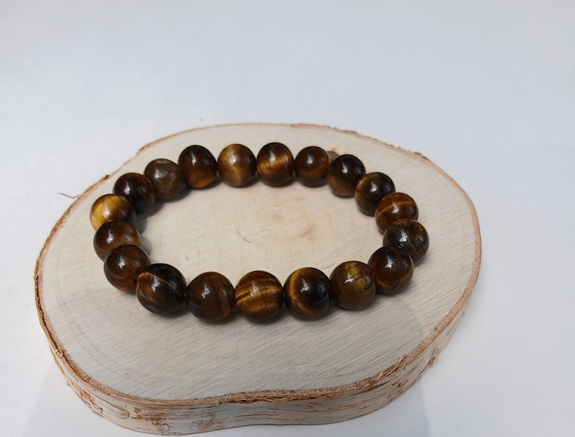Tiger Eye Bracelet for men featuring natural healing crystals known for protection, strength, and balance. This stylish spiritual jewelry is designed to promote positive energy and calm, making it a meaningful gift for him—perfect for husbands or boyfriends. Handmade with quality beads, it combines durability and fashion for everyday wear. Ideal for meditation, casual outfits, or special occasions, blending wellness with masculine style.