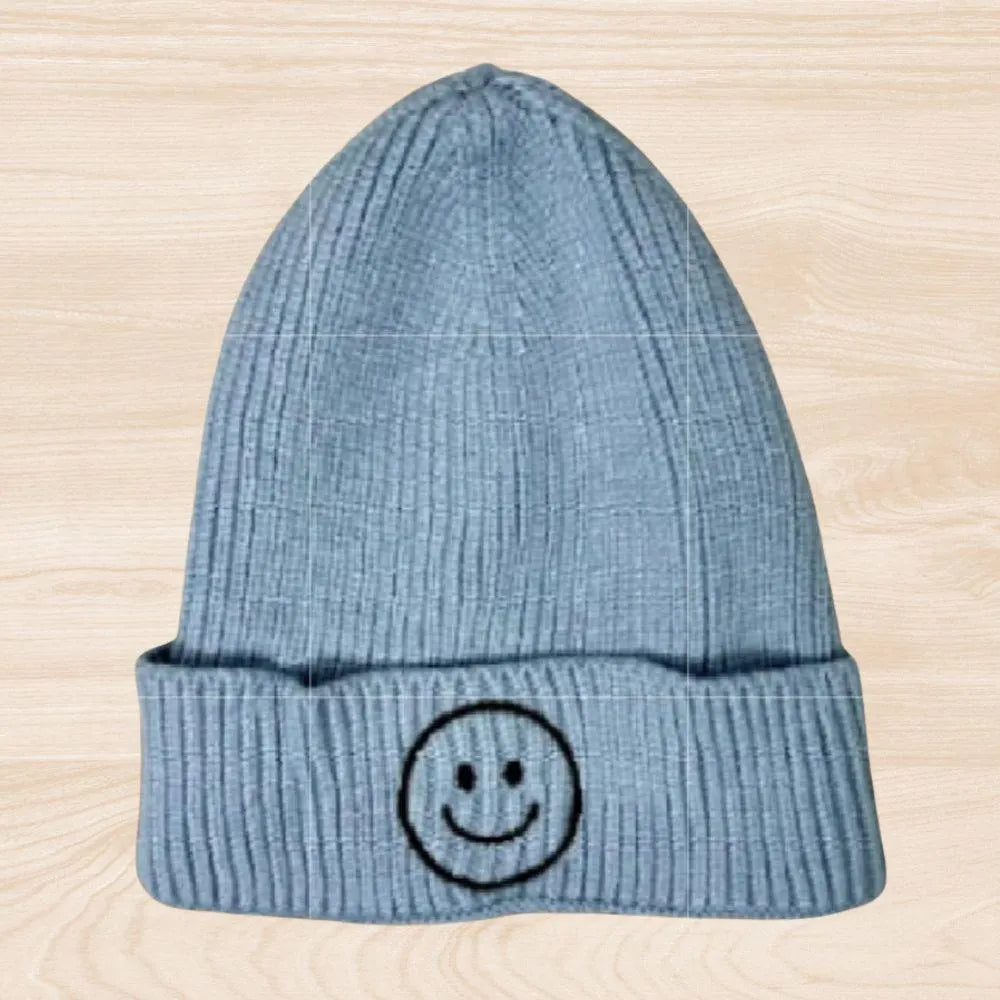 Trendy smiley face beanie hat made from cozy knit fabric, perfect for kids, teens, and adults. This fun and stylish hat adds warmth and personality to any fall, winter, or spring outfit. With its cheerful embroidered design, it’s a great gift idea and a playful accessory for all ages. Comfortable and eye-catching, this knit beanie offers both fashion and function, keeping you warm while spreading positive vibes in cooler weather.