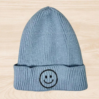 Trendy smiley face beanie hat made from cozy knit fabric, perfect for kids, teens, and adults. This fun and stylish hat adds warmth and personality to any fall, winter, or spring outfit. With its cheerful embroidered design, it’s a great gift idea and a playful accessory for all ages. Comfortable and eye-catching, this knit beanie offers both fashion and function, keeping you warm while spreading positive vibes in cooler weather.
