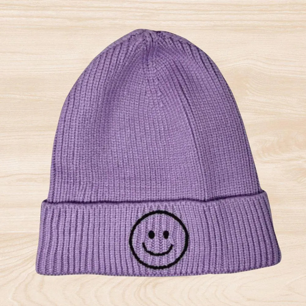 Trendy smiley face beanie hat made from cozy knit fabric, perfect for kids, teens, and adults. This fun and stylish hat adds warmth and personality to any fall, winter, or spring outfit. With its cheerful embroidered design, it’s a great gift idea and a playful accessory for all ages. Comfortable and eye-catching, this knit beanie offers both fashion and function, keeping you warm while spreading positive vibes in cooler weather.