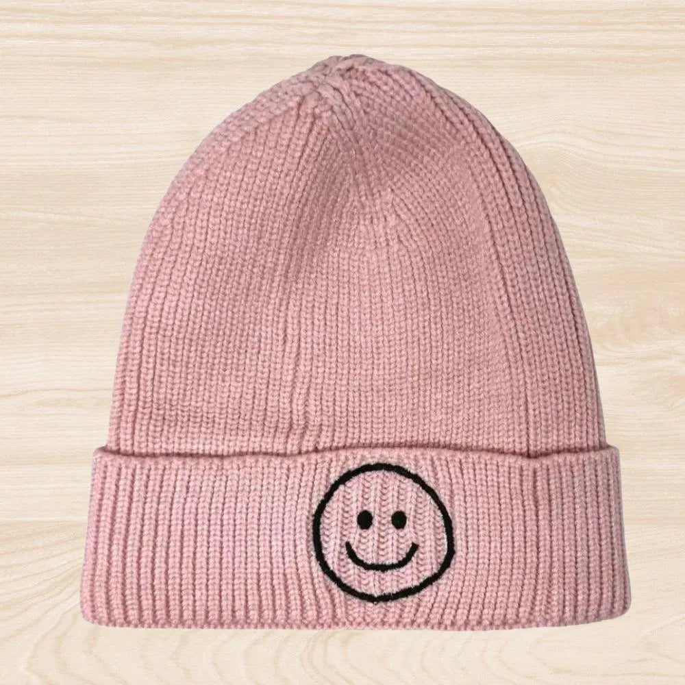 Trendy smiley face beanie hat made from cozy knit fabric, perfect for kids, teens, and adults. This fun and stylish hat adds warmth and personality to any fall, winter, or spring outfit. With its cheerful embroidered design, it’s a great gift idea and a playful accessory for all ages. Comfortable and eye-catching, this knit beanie offers both fashion and function, keeping you warm while spreading positive vibes in cooler weather.