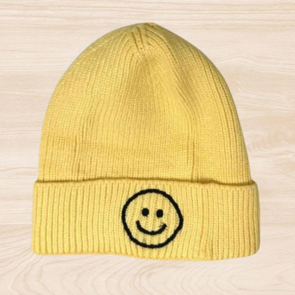 Trendy smiley face beanie hat made from cozy knit fabric, perfect for kids, teens, and adults. This fun and stylish hat adds warmth and personality to any fall, winter, or spring outfit. With its cheerful embroidered design, it’s a great gift idea and a playful accessory for all ages. Comfortable and eye-catching, this knit beanie offers both fashion and function, keeping you warm while spreading positive vibes in cooler weather.