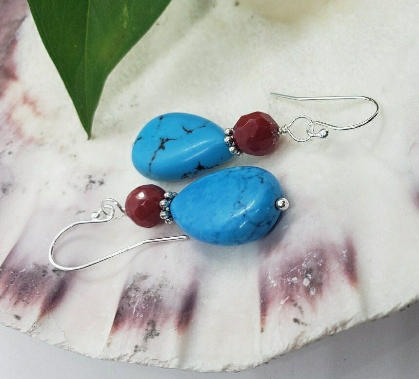 Turquoise and Red Coral Sterling Silver Earrings featuring a handmade water drop design crafted for women who love bold, natural gemstone jewelry. These unique earrings combine vibrant turquoise and rich red coral with elegant sterling silver accents, creating a striking boho-chic accessory. Perfect as a thoughtful gift, they offer a pop of color and artisan charm, ideal for everyday wear or special occasions. Lightweight and eye-catching with timeless appeal.
