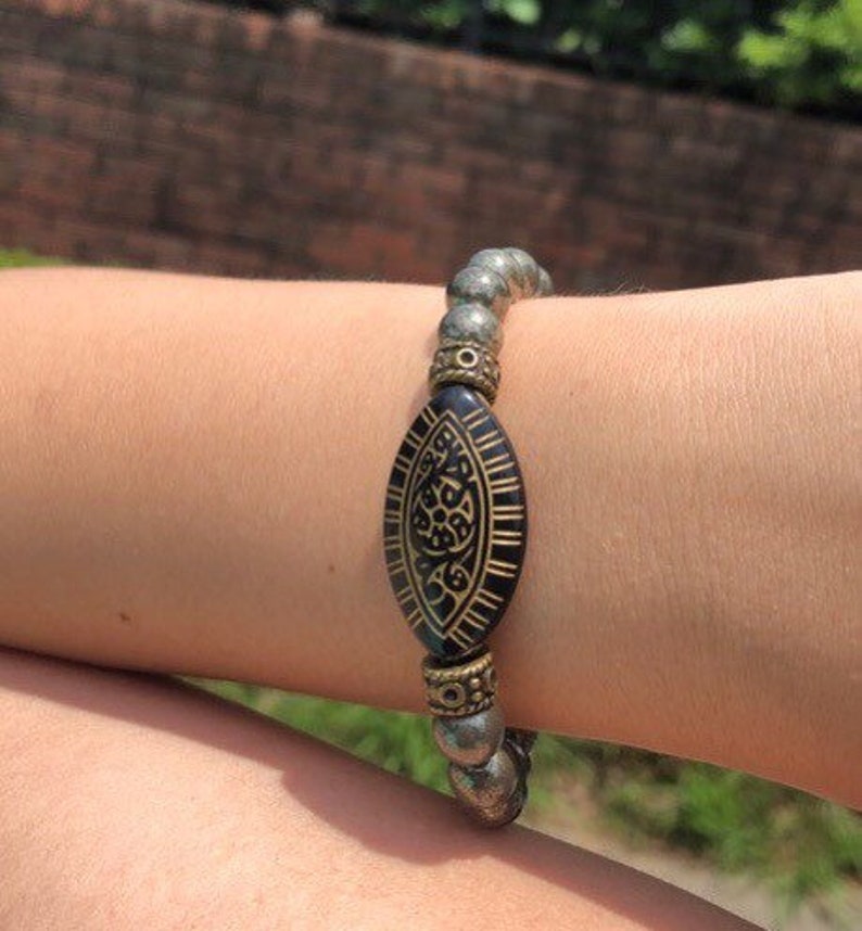 Pyrite Bracelet with 8mm handmade beaded crystals, designed to promote abundance, good luck, and positive spiritual energy. This unisex bracelet combines shimmering pyrite stones crafted into a stylish accessory for both women and men. Perfect as a meaningful gift, it supports confidence, prosperity, and protection. Lightweight and versatile, this abundance bracelet blends healing properties with elegant, handmade jewelry for everyday wear or special occasions.