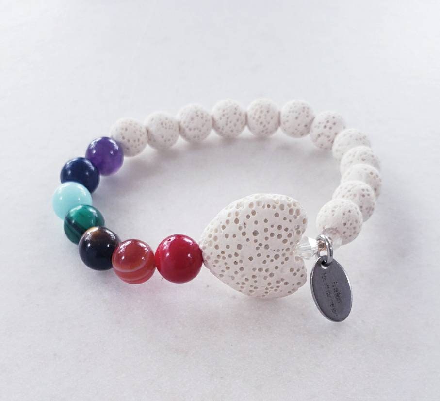 Handmade white lava stone diffuser bracelet designed for women, featuring natural volcanic stones known for their healing and chakra balancing properties. This stretch bracelet combines crystal healing benefits with stylish, lightweight comfort, perfect for everyday wear or meditation practices. Ideal as a thoughtful gift, it allows essential oils to be diffused throughout the day, blending wellness with elegant, natural jewelry design.
