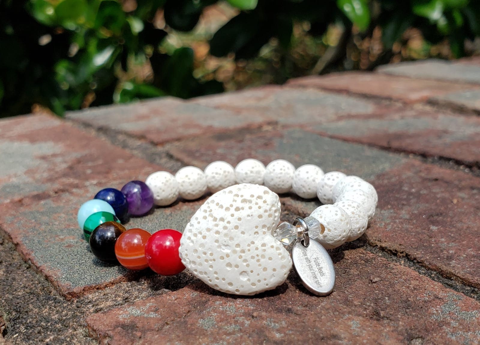 Handmade white lava stone diffuser bracelet designed for women, featuring natural volcanic stones known for their healing and chakra balancing properties. This stretch bracelet combines crystal healing benefits with stylish, lightweight comfort, perfect for everyday wear or meditation practices. Ideal as a thoughtful gift, it allows essential oils to be diffused throughout the day, blending wellness with elegant, natural jewelry design.