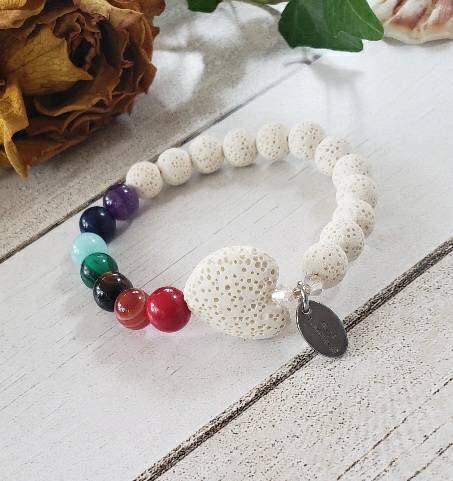 Handmade white lava stone diffuser bracelet designed for women, featuring natural volcanic stones known for their healing and chakra balancing properties. This stretch bracelet combines crystal healing benefits with stylish, lightweight comfort, perfect for everyday wear or meditation practices. Ideal as a thoughtful gift, it allows essential oils to be diffused throughout the day, blending wellness with elegant, natural jewelry design.