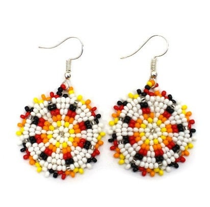Handmade white and yellow beaded earrings in native ethnic style, featuring intricate tribal medallion design. These artisan statement earrings are perfect for women who appreciate unique, handcrafted jewelry inspired by traditional tribal patterns. Lightweight and bold, they make an excellent gift and add a touch of cultural elegance to any outfit, ideal for everyday wear or special occasions with a vibrant ethnic flair.