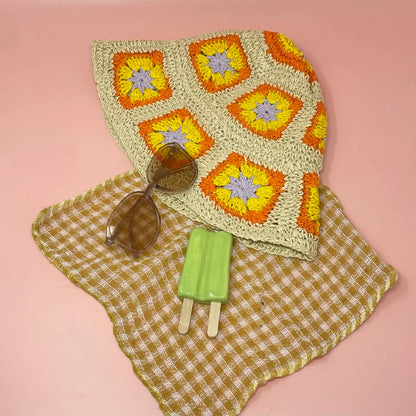 Yellow Cottage Summer Sun Hat featuring a crochet bucket design with orange and brown flower patterns, crafted with a wide brim for optimal sun protection. This lightweight fisherman beach hat for women is perfect for travel, outdoor activities, and casual summer wear. Combining vintage cottagecore charm with practical functionality, it offers breathable comfort and a stylish accessory to enhance any warm-weather outfit or vacation look.
