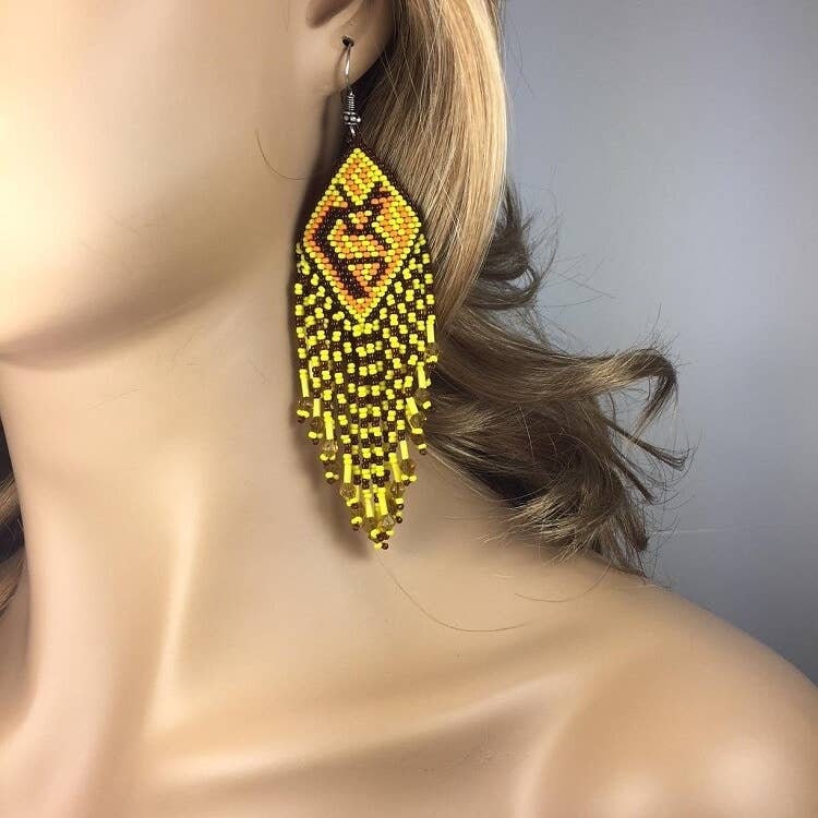Handmade Yellow Beaded Earrings featuring large Kokopelli designs crafted in boho sterling silver jewelry style. These statement earrings for women showcase vibrant yellow beads combined with intricate Kokopelli motifs, perfect for adding bold, artistic flair to any outfit. Ideal as a unique gift for her, they blend cultural symbolism with trendy, handcrafted elegance. Lightweight and durable, these earrings are perfect for festivals, casual wear, or special occasions.